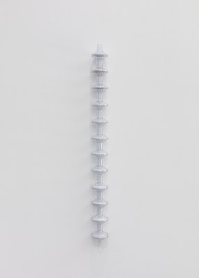 A hanging sculpture. The sculpture is made out of twelve pieces of transparent plastic interlocking into one another in a vertical column. Each piece is a cylindrical tube leading to a flattened sphere leading to a cylindrical tube. In the center of each flattened sphere is a filter.