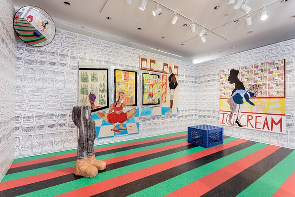 Another installation view of the gallery. From this angle we can see a traffic mirror installed in the top corner to our left. It reflects back the striped floor, sculptures and wall works in its range. To the right, on the back wall, there are two large paintings that are hung together but at offset heights. Both paintings seem to represent a grocery or convienience store. There are bottles in cases and two people appear to be shopping. On the right wall is a large painting with the words "ice cream" written in red capital letters at the bottom. The painting shows a woman in high heels bending over and a silhouette of a man's face and shoulders looking in the other direction. In front of the painting is a large plastic milk crate. To our left is a large free standing sculpture of legs and feet.