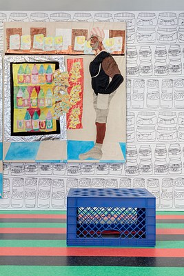 Another installation view of the gallery focusing on the blue overturned milk crate and one of the paintings on the back wall. Through the perforations in the blue plastic of the crate we can see the black, green and orange flooring. The crate is overturned, with its bottom up, as if about to be used as a step stool, chair or table. On the back wall is a large wall work. On stretched canvas, painted fabric has been collaged into an image of a man in profile facing a refrigerated cabinet of drinks. On a shelf above (at his head height) is a row of boxes marked "Pampers" with an image of a baby drawn. The man is dark skinned with a gray beard and mustache. He is wearing a pink and white striped cap, a black tank top, and gray shorts, gray shoes and socks. He is standing with his hands on his hips on a blue and white checked floor.