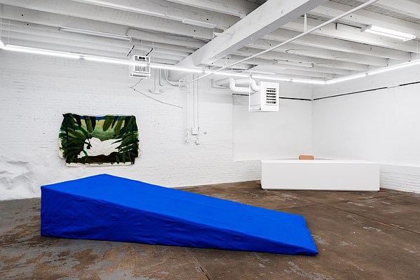 Installation view showing "Cerulean: Big Sur Summer 2010" in the foreground. This piece is a large, interactive soft sculpture that is the embodiment of the tidal pool in northern California, Big Sur. It is 30 inches tall, 60 inches wide, and 142 inches long. The sculpture is large enough for 4 people to sit, or recline on it at once. It is padded with soft memory foam, and lined with blue felt giving the sensation of floating and sinking as if in water.. . In the background is an oil painting on a twin sized bed sheet, “Looking Through the Leaves at Two Lovers Making Out”. This is a landscape painting, 48 inches tall, and 64 inches long. If you look closely, you can see a floral pattern from the original bed linen. It shows the outlines of two figures kissing, but leaves in the foreground kind of obscure your view.
