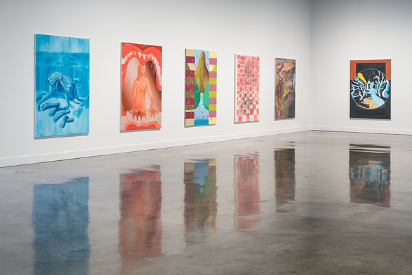 Six oil paintings of varied imagery hang on two gallery walls; five on one wall, one on the far intersecting wall.