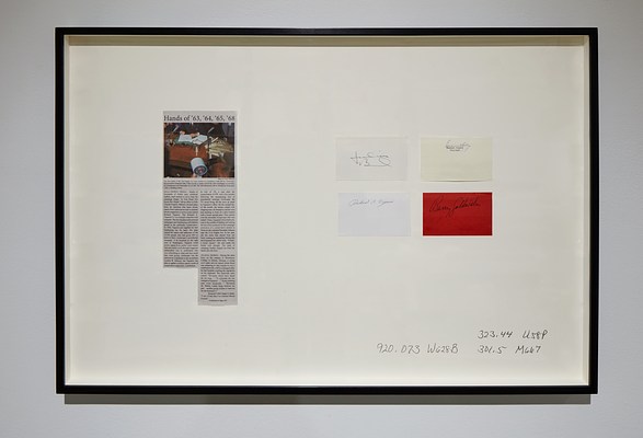  Framed work with a newspaper clipping, 4 signatures on rectangles of colored paper, &amp; 3 silkscreened  library call numbers.