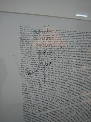 A detail of a white framed wall work on a white wall. The detail has been drawn over with black squiggles of ink. Part of the first line is readable: . "White Night. The first night. It was a non existence, which I inhabited, so to speak, since I had left ..."