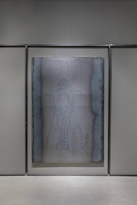 A large, vertical welded steel drawing hanging in the center of a wall in between two vertical steel bars and one horizontal bar above.